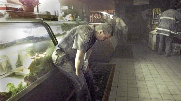 Officer Richard Adamiak yelled at Ruth Fremson after she took his photo as he caught his breath inside the Stage Door Deli.