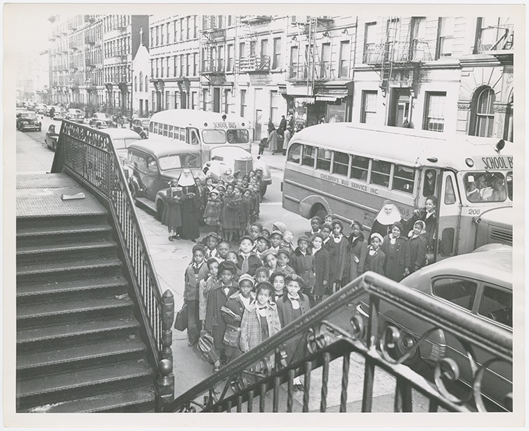Old days in Harlem (Gallery and Videos) 13 Old days in Harlem: View of two busloads of Catholic school children arriving for class at St. Charles Borromeo Church, on West 142nd Street