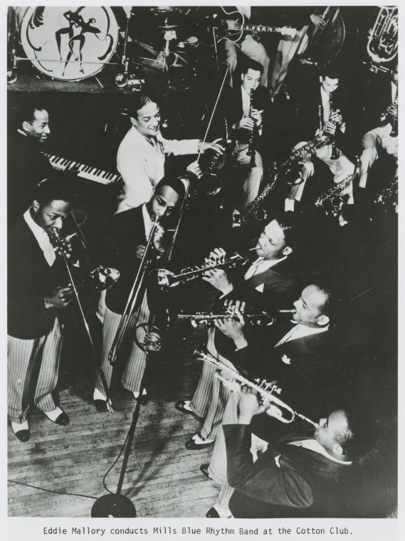 Old days in Harlem (Gallery and Videos) 16 Old days in Harlem: Eddie Mallory conducts Mills Blue Rhythm Band at the Cotton Club.